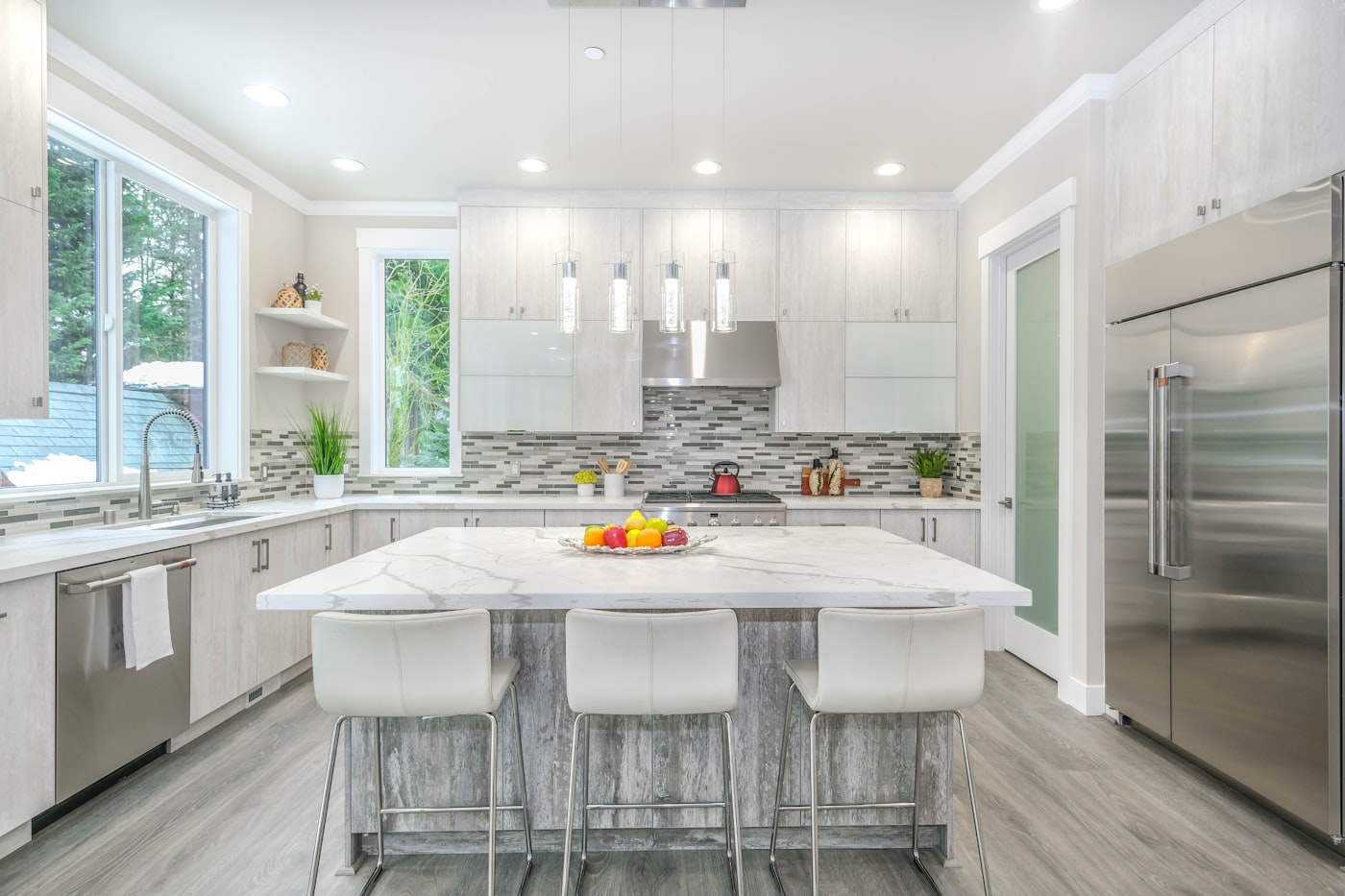 Bright renovated kitchen with island and stone worktops