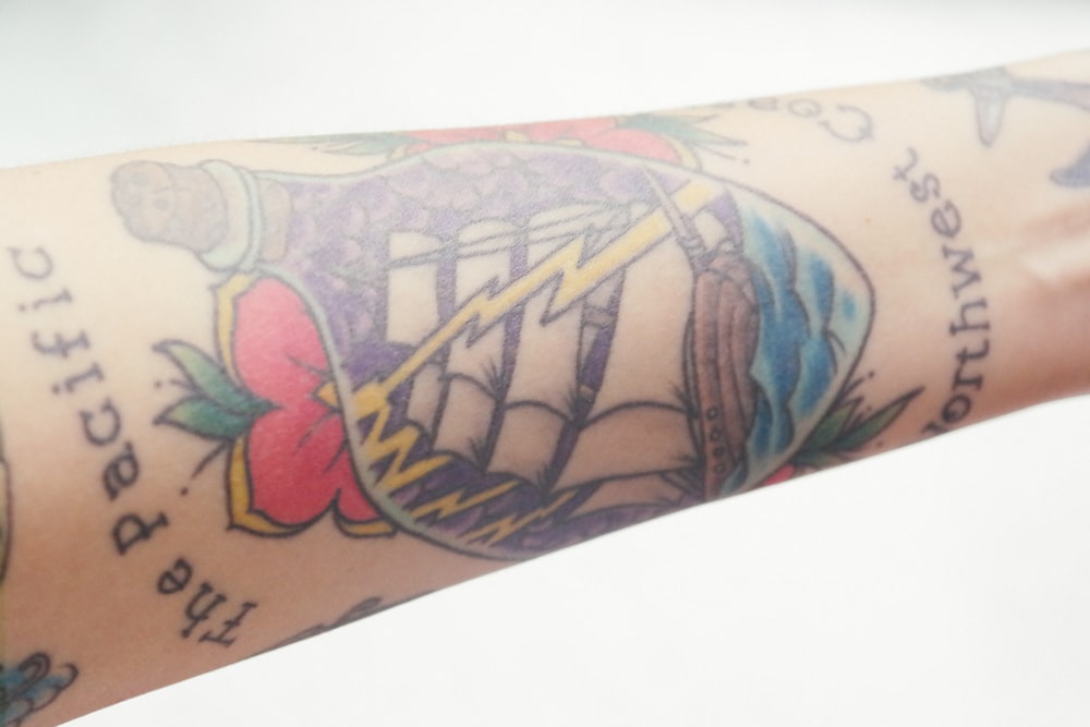Traditional ship in a bottle forearm tattoo