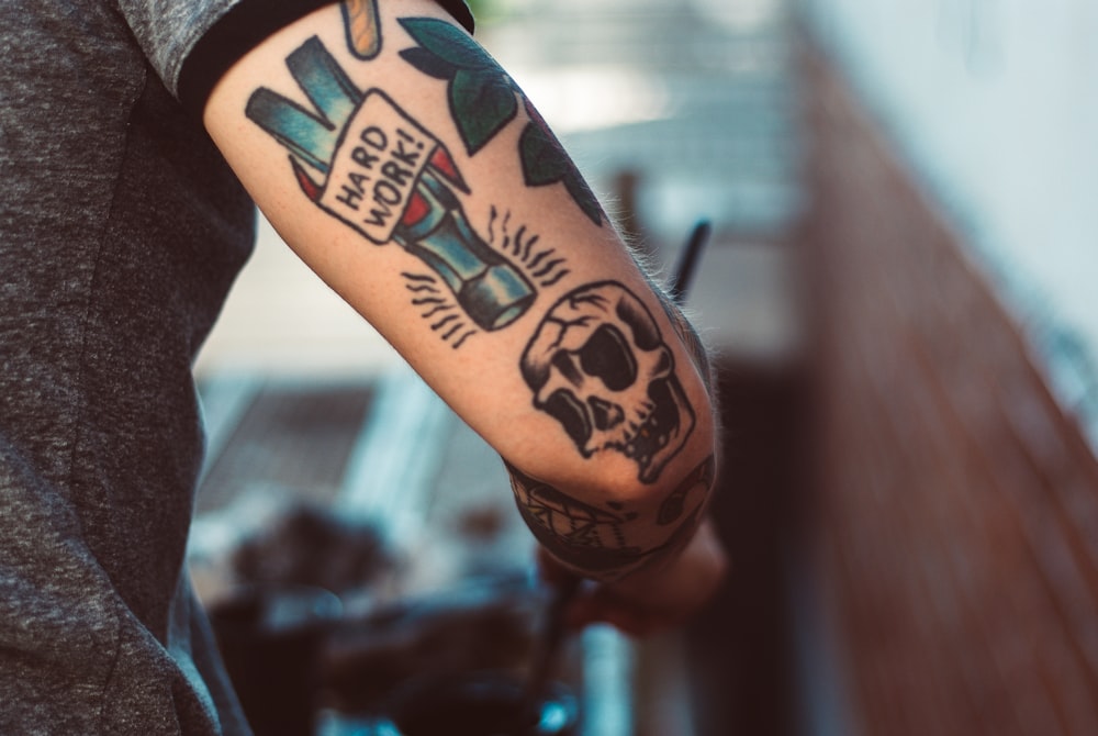 American traditional skull and hard work banner tattoo