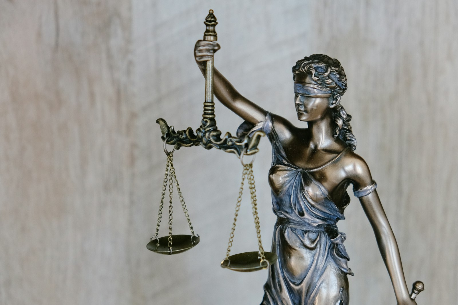 Bronze statue of Lady Justice holding the scales