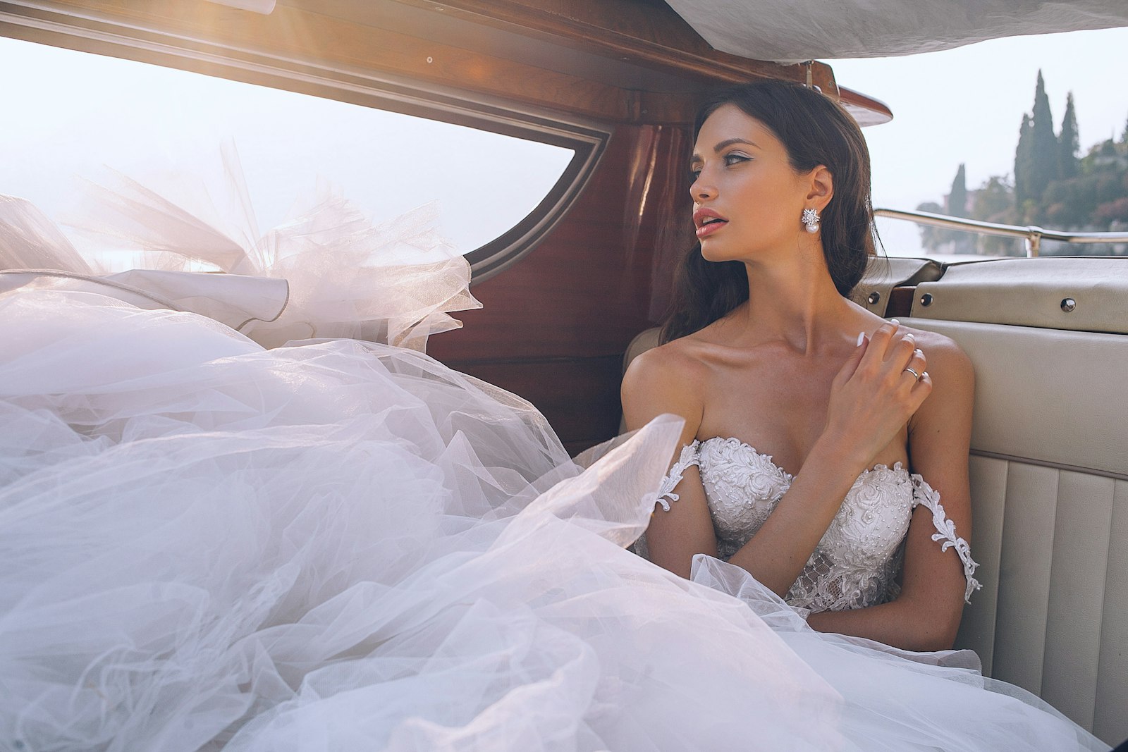 Elegant bride in a vintage wedding car